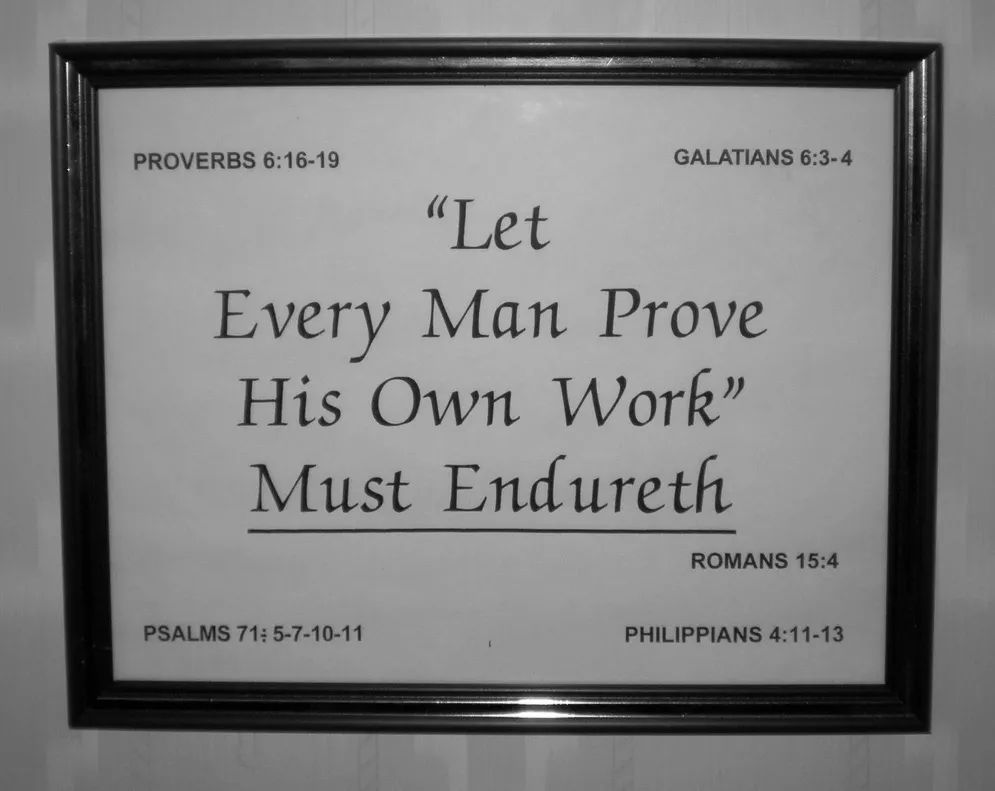 A framed picture of bible verses on the wall.